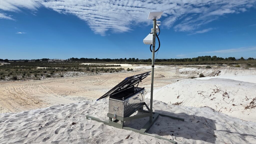 Air quality monitor pod mounted on a post at a site boundary